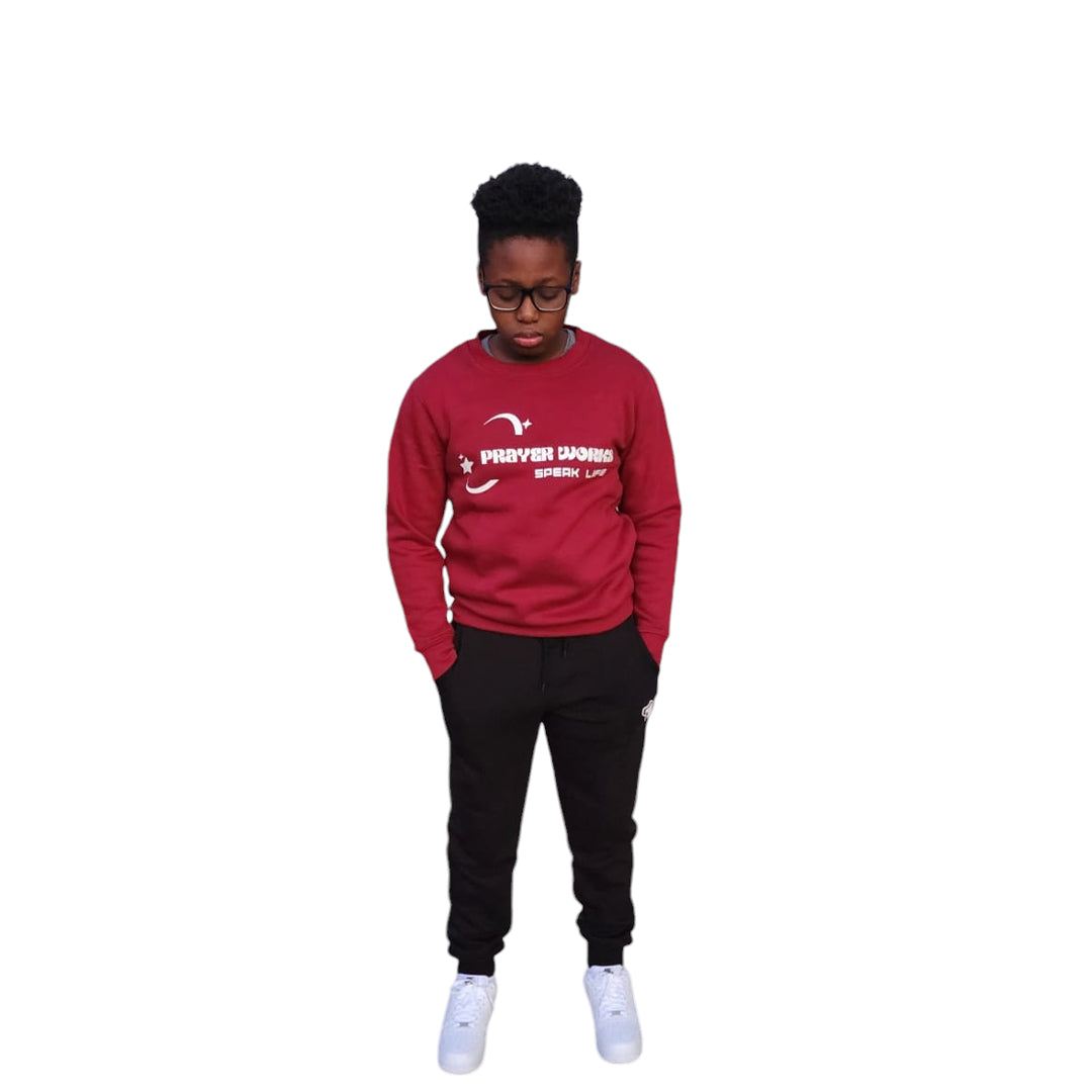 Prayer Works Speak Life Inspirational Crewneck worn by a person standing.