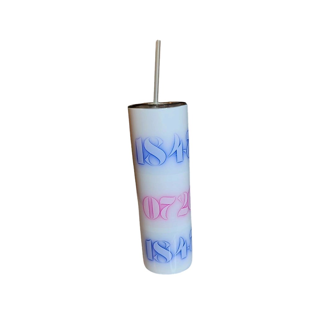 Stainless steel tumbler with colorful design and straw.