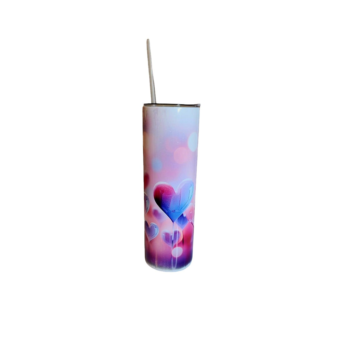 Colorful tumbler with heart design and straw for hot and cold drinks.